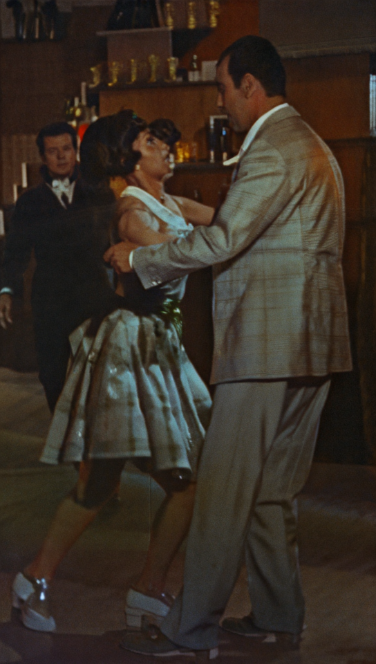 Couple dancing at 1950s jazz club with vintage film look